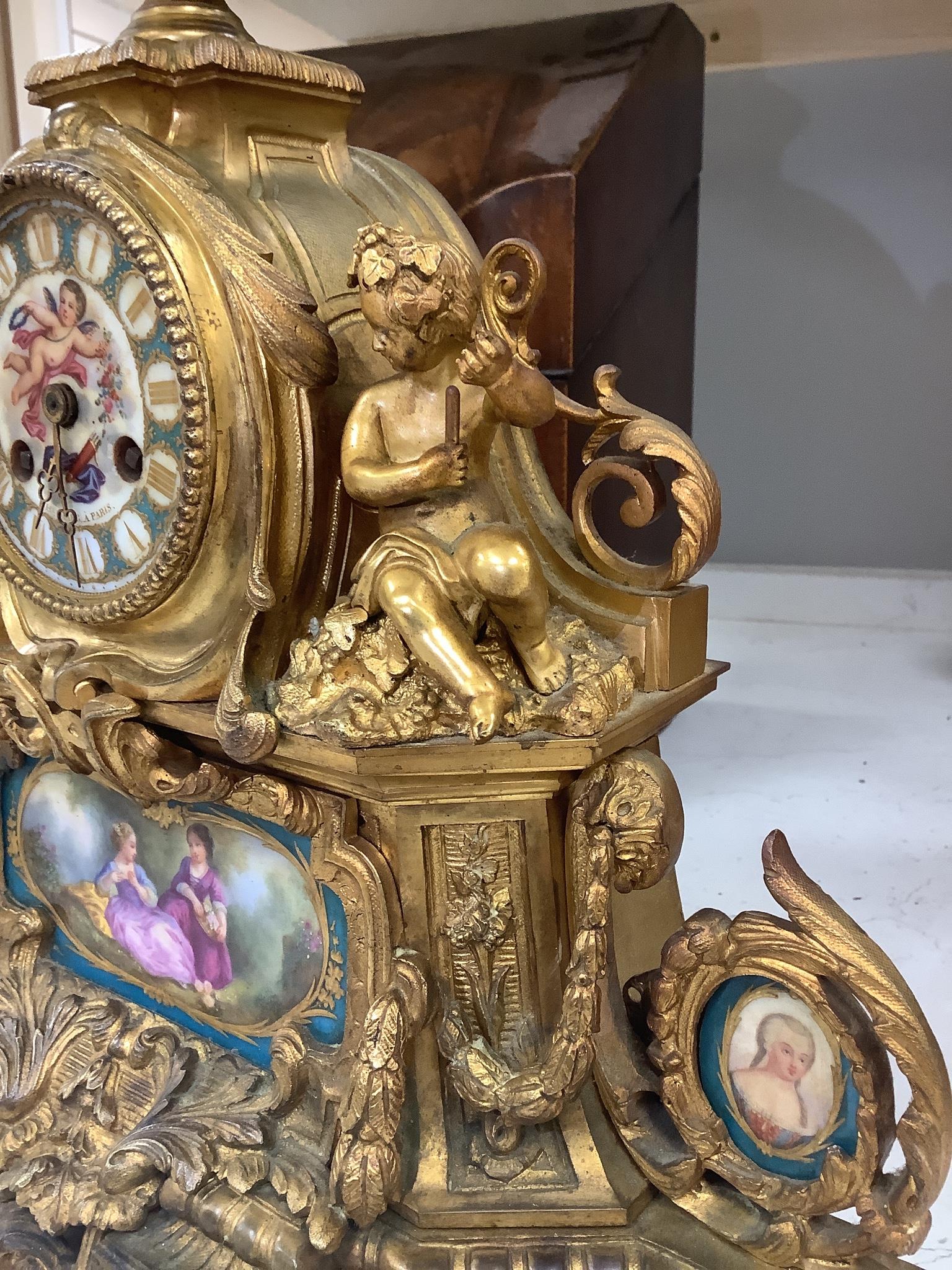 A 19th century French ormolu and Sevres style porcelain mounted mantel clock, with key and pendulum, 35 cm high